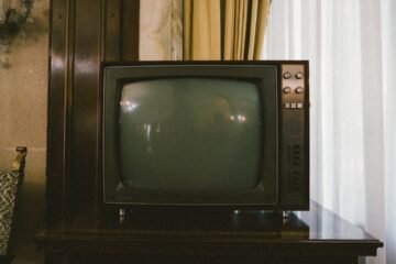 Old CRT television compared to a modern flat screen TV