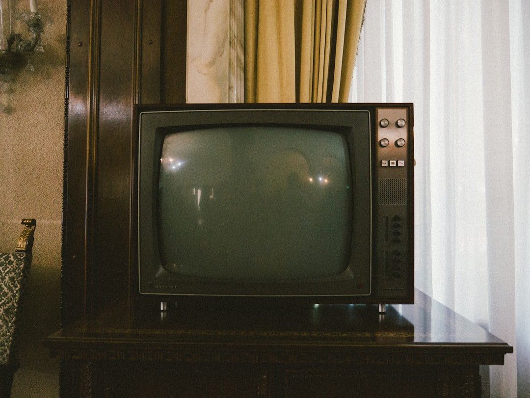 Old CRT television compared to a modern flat screen TV